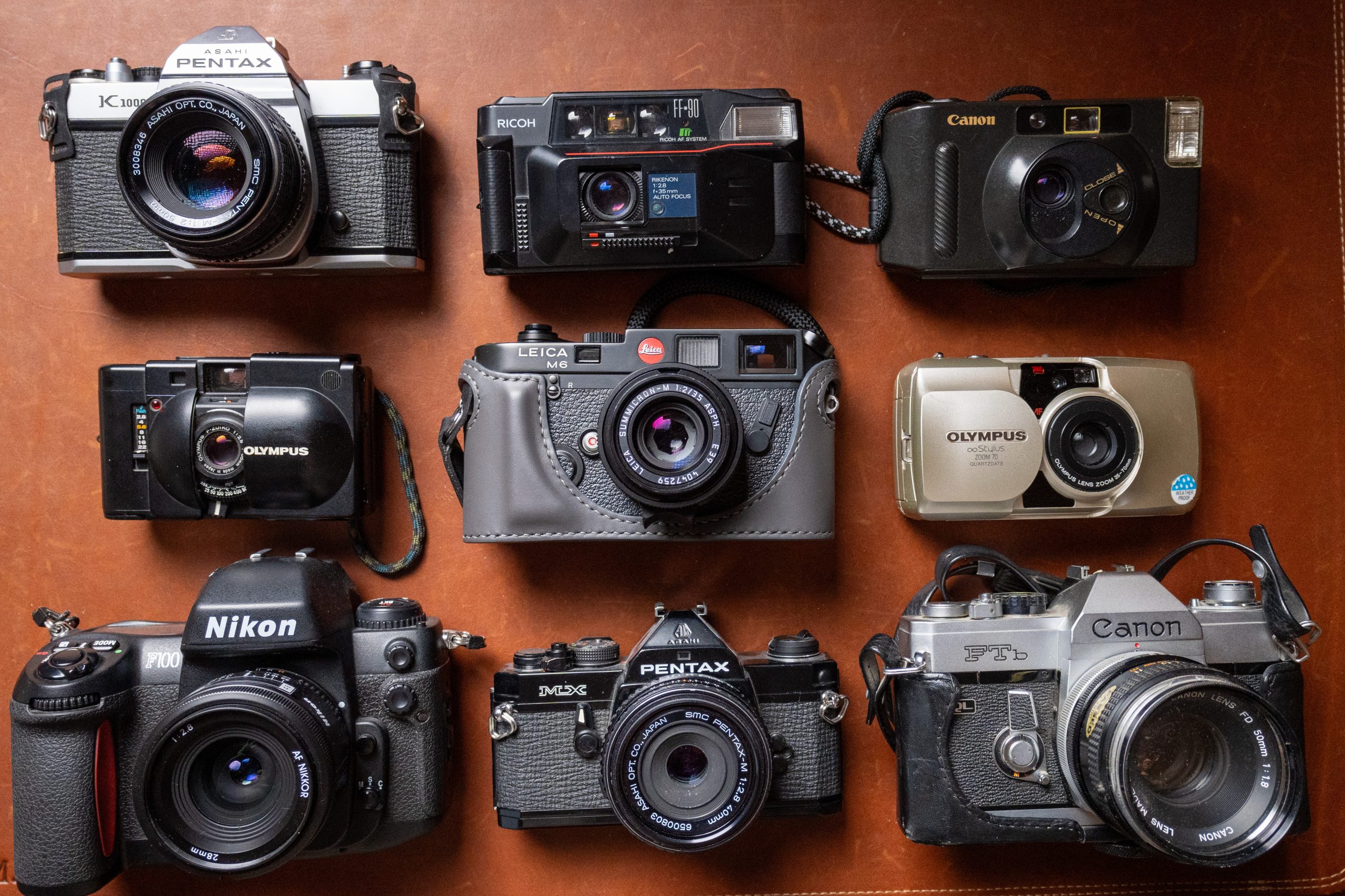 Different styles and brands of film cameras.