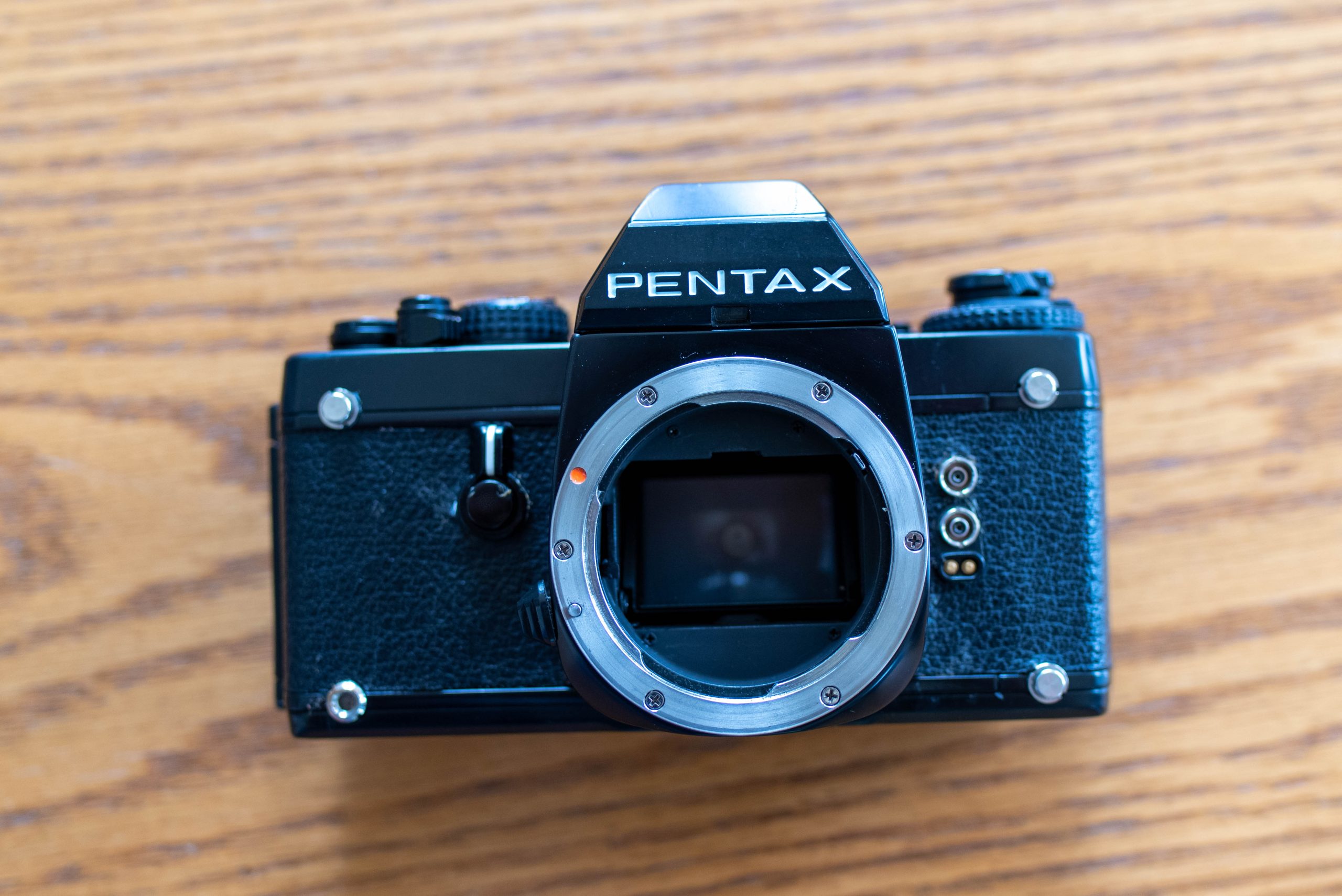 A Pentax LX film camera without a lens attached.