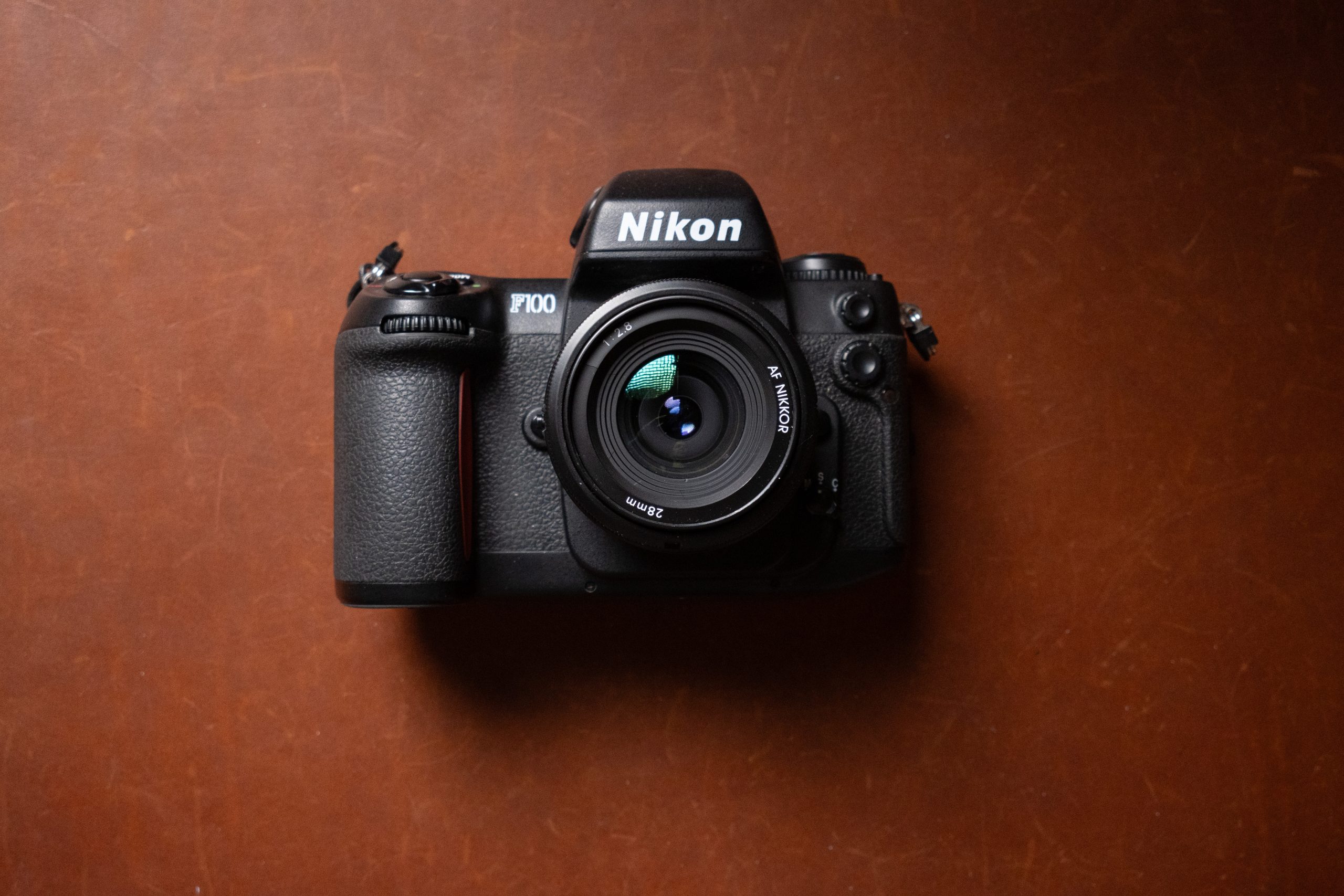 A Nikon F100 film camera with 28mm lens.