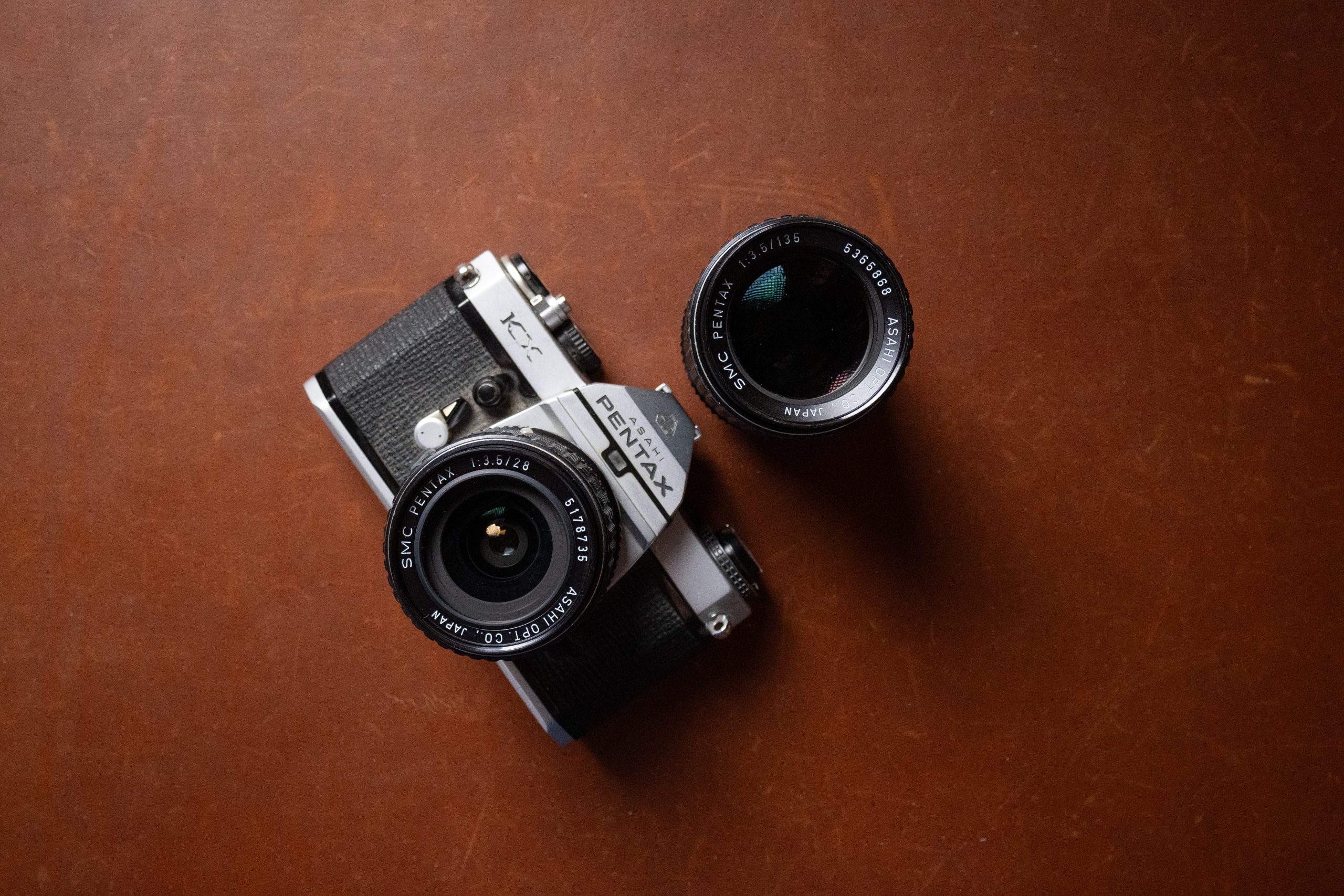 A Pentax KX 35mm film camera with Pentax 28mm 3.5 and Pentax 135mm 3.5