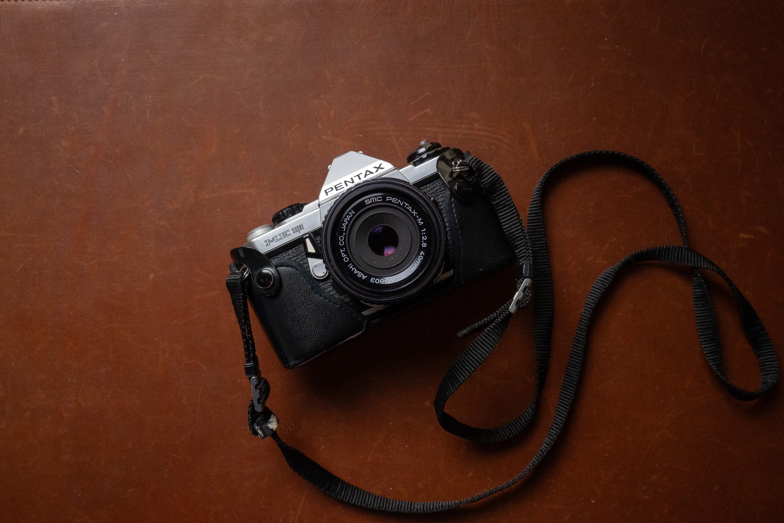 A Pentax ME Super 35mm film camera with 40mm 2.8 pancake lens.