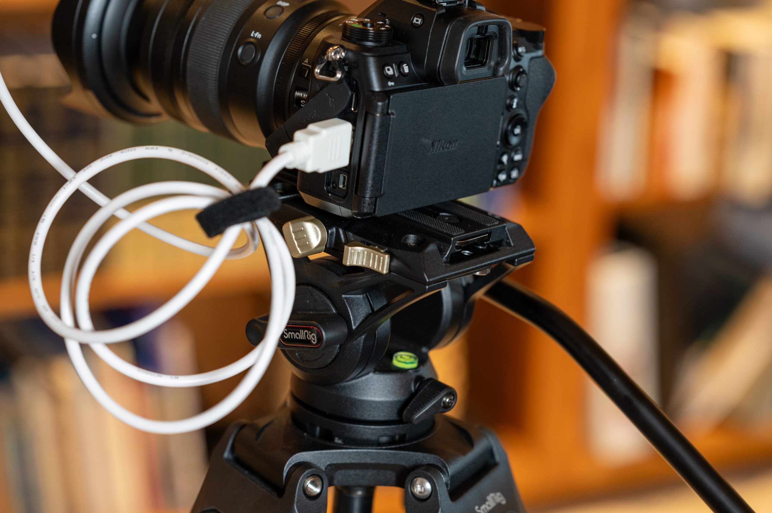 Close-up of a camera mounted on the SmallRig AD-01 tripod's fluid head, highlighting its smooth panning and tilting capabilities for video motions.